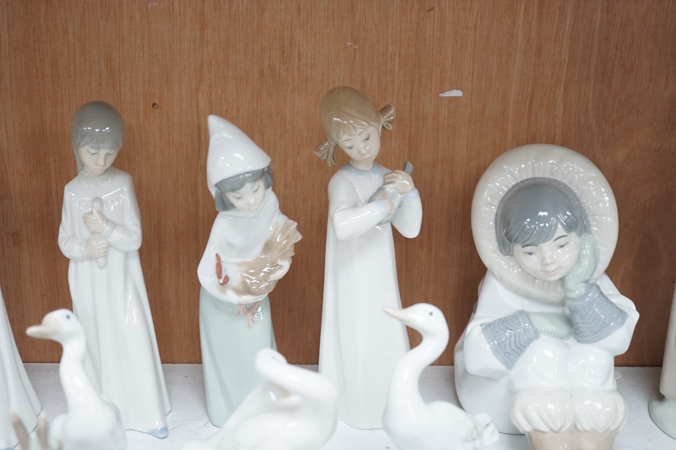 Lladro figurines, models of ducks and six Nao figurines and ducks and an unmarked model of ducks